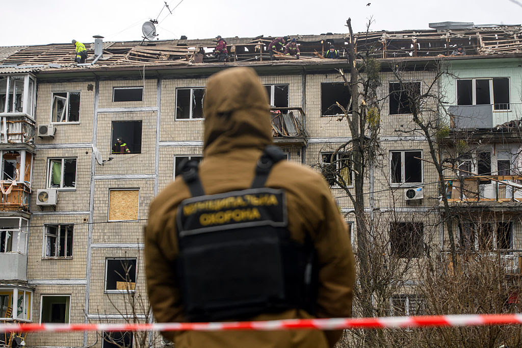 A person in a uniform standing in front of a building

AI-generated content may be incorrect.