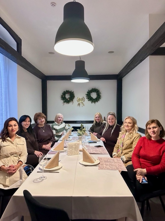 A group of women sitting at a table

AI-generated content may be incorrect.