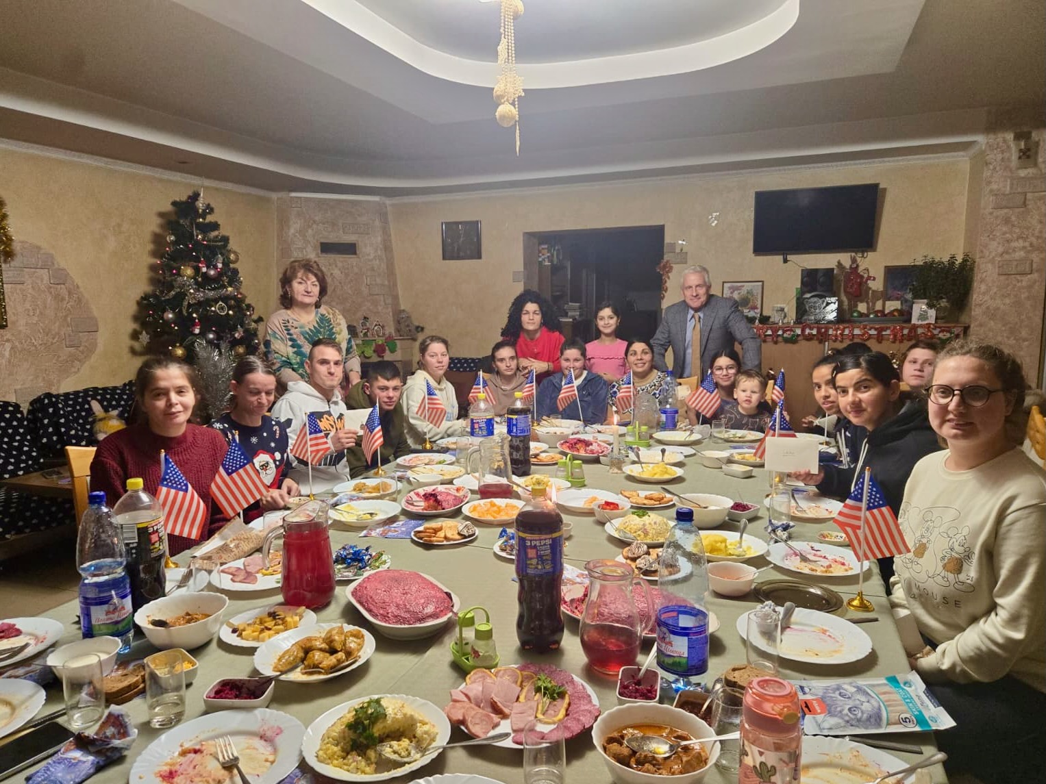 A group of people around a table with food

AI-generated content may be incorrect.