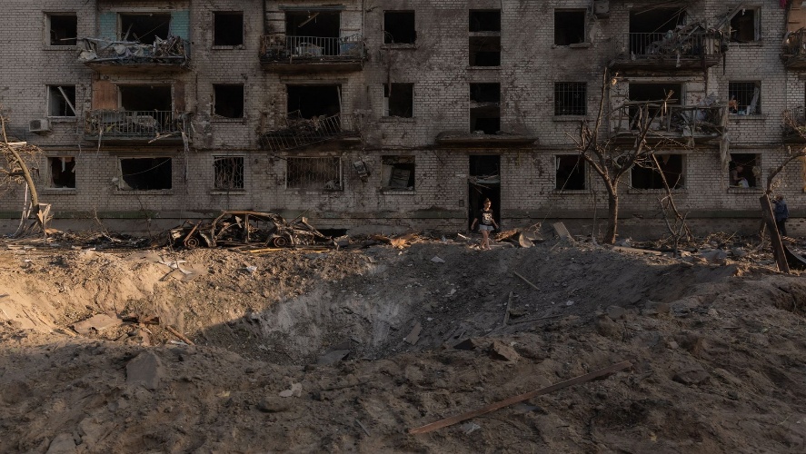 A person walks away from a residential building damaged in a Russian air attack on Kyiv, Ukraine, on July 2, 2026. 