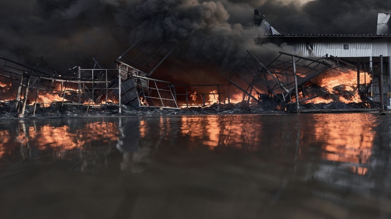 Smoke rises from a fire at a large warehouse storing car tires and wheels following a Russian strike in Bucha district, Kyiv Oblast, Ukraine, on Aug. 29, 2026.