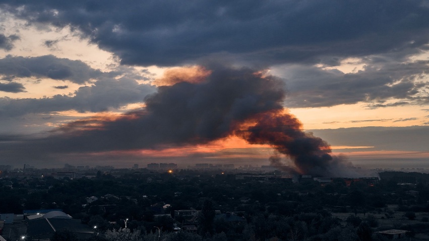 Smoke rises from a warehouse destroyed during Russian ballistic missile and drone strikes next to a residential building on the outskirts of Kyiv, Ukraine, early on Aug. 5, 2026.