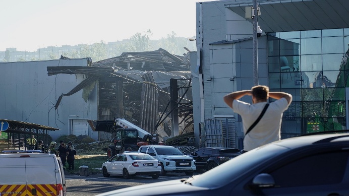 A man looks at a shopping center damaged by a Russian drone strike in Kryvyi Rih, Ukraine, on Aug. 22, 2026