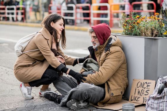 Woman helping a needy person